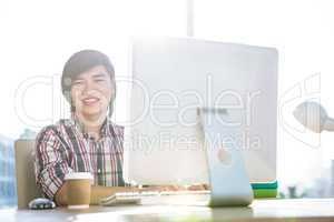 Smiling hipster businessman using computer
