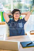 Smiling asian businessman listening to music