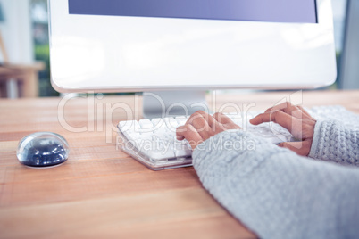 Womans hands typing on computer keyboard