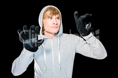 Man with black gloves hitting glass