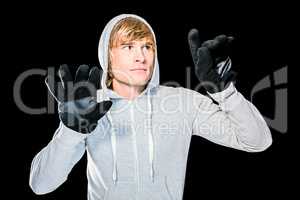 Man with black gloves hitting glass