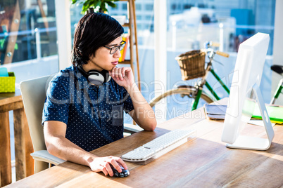 Serious hipster businessman using computer