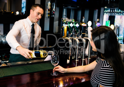 Barman serving a glass of wine