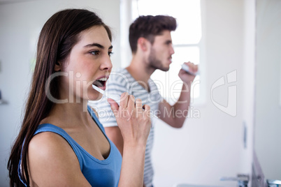 Couple brushing their teeth