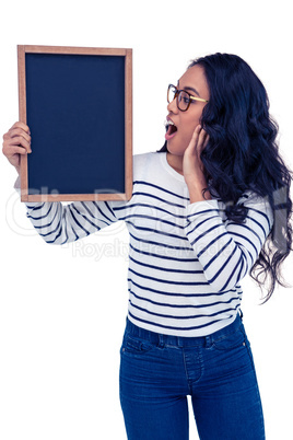 Surprised Asian woman holding blackboard