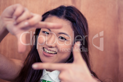 Asian woman making square with hands
