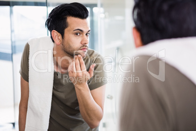 Handsome man looking in mirror