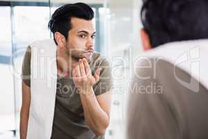 Handsome man looking in mirror