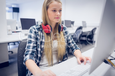 Serious student working on computer