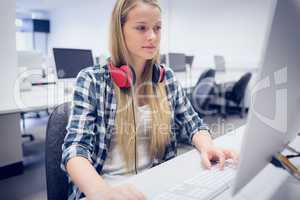 Serious student working on computer