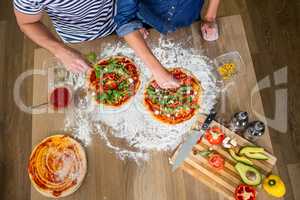 Smiling couple preparing pizza