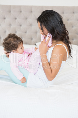 Brunette playing with her baby