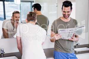 Smiling gay couple in the bathroom