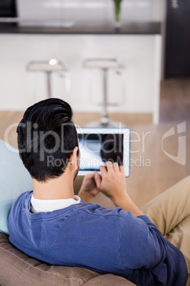 Man using tablet on the couch