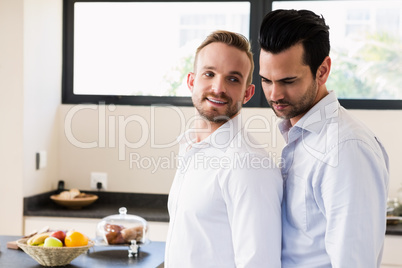 Smiling gay couple in the kitchen Smiling gay couple in the kitchen