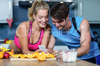 Healthy couple looking at smartphone