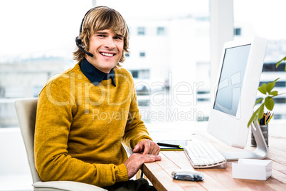 Smiling hipster businessman using headset