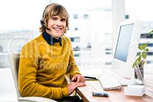 Smiling hipster businessman using headset