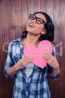 Asian woman holding paper heart