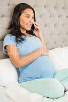 Pregnant brunette on phone call