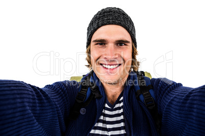 Smiling backpacker hipster holding the camera