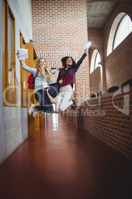 Happy female students receiving results