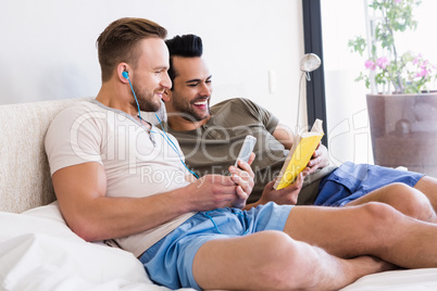 Happy gay couple reading book