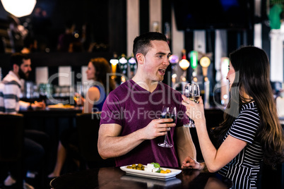 Couple having an aperitif with wine