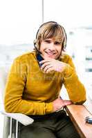 Smiling hipster businessman using headset