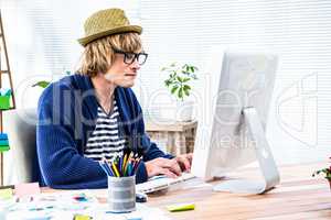 Serious hipster businessman working on computer