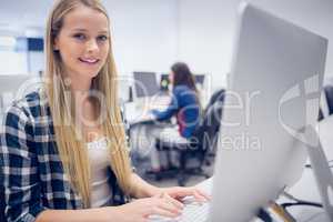 Smiling student working on computer