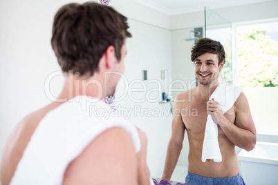 Handsome man standing with towel