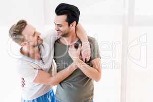 Smiling gay couple hugging