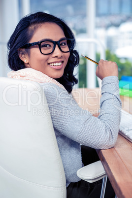 Asian businesswoman holding pencil