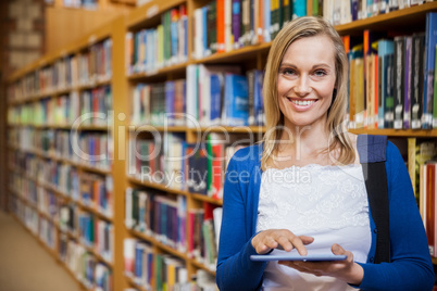 Female student using tablet in the library