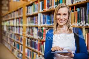 Female student using tablet in the library