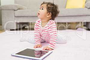 Cute baby on the carpet with tablet