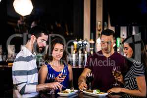 Friends having an aperitif with wine