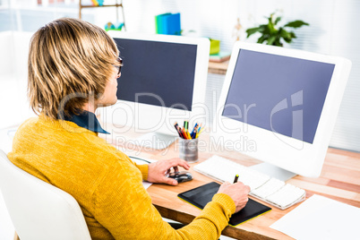 Rear view of hipster businessman using tablet graphic