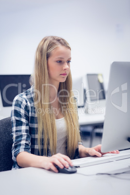 Serious student working on computer