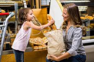 Mother and daughter taking bread