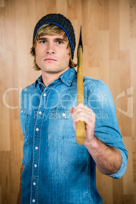 Front view of hipster standing with axe