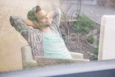 Smiling designer relaxing at the desk