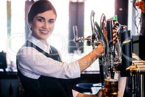 Barmaid serving a pint