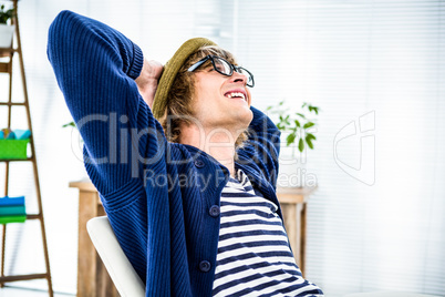 Smiling hipster businessman takes a break