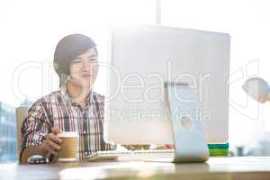 Smiling hipster businessman using computer