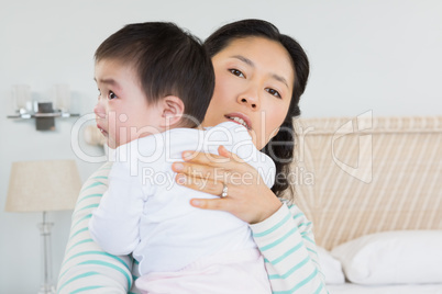 Lovely mother holding baby daughter