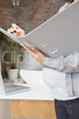 Pregnant woman holding folder