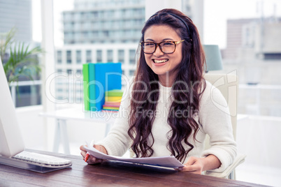 Smiling Asian woman holding documents