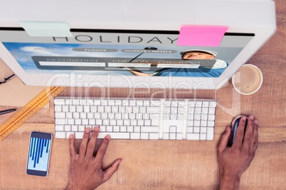Composite image of businessman using computer while working at d